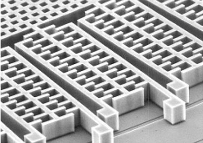 Micromachined proof mass interleaved with capacitive sensors 