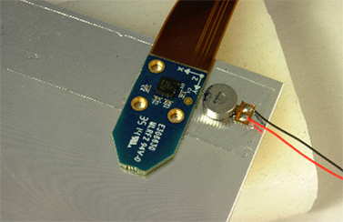 Image of Texas Instruments accelerometer board and the vibration actuator